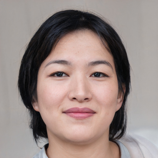 Joyful white young-adult female with medium  black hair and brown eyes