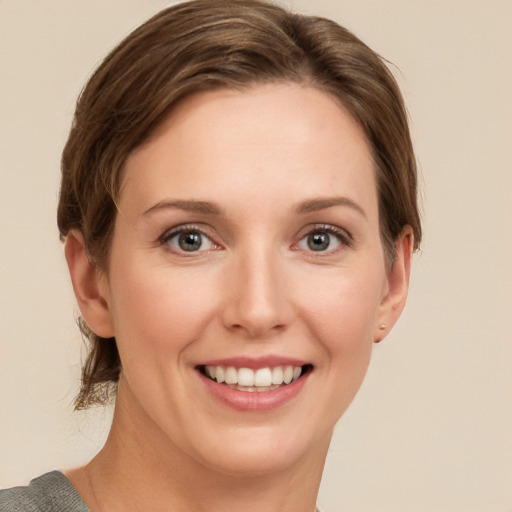 Joyful white young-adult female with short  brown hair and grey eyes