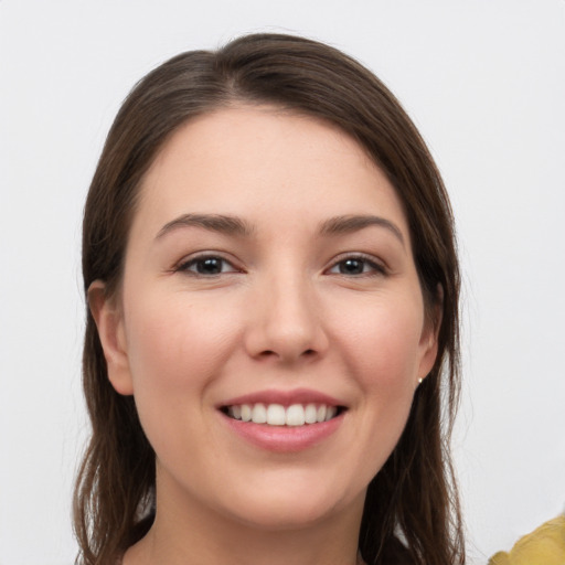 Joyful white young-adult female with long  brown hair and brown eyes