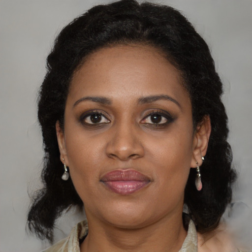 Joyful black adult female with medium  brown hair and brown eyes