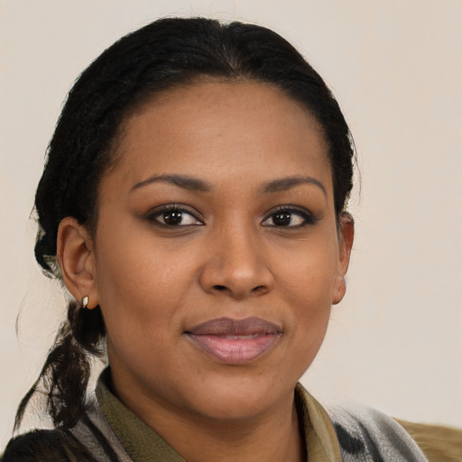 Joyful black young-adult female with medium  black hair and brown eyes