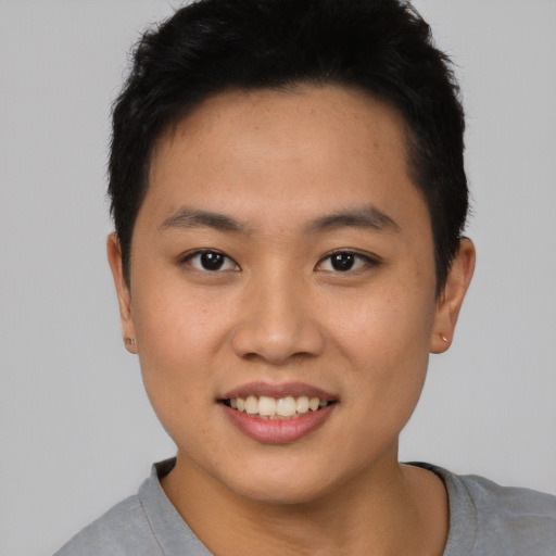 Joyful asian young-adult male with short  black hair and brown eyes