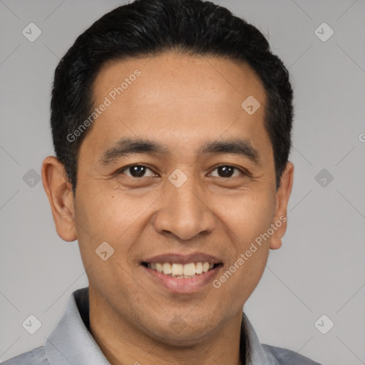 Joyful latino young-adult male with short  black hair and brown eyes