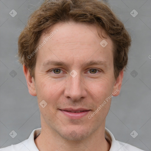 Joyful white adult male with short  brown hair and grey eyes