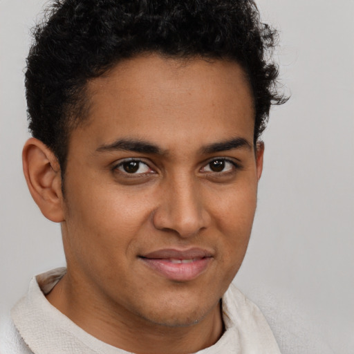 Joyful latino young-adult male with short  brown hair and brown eyes