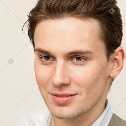 Joyful white young-adult male with short  brown hair and brown eyes