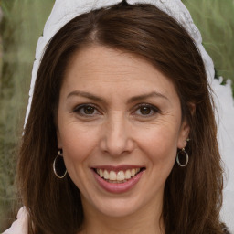 Joyful white adult female with medium  brown hair and brown eyes