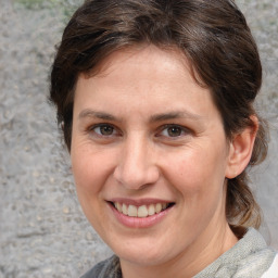 Joyful white adult female with medium  brown hair and brown eyes