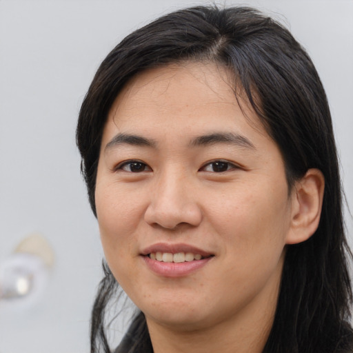 Joyful asian young-adult female with medium  brown hair and brown eyes