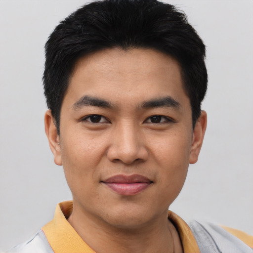 Joyful asian young-adult male with short  black hair and brown eyes