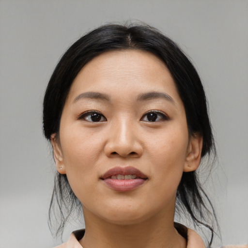 Joyful asian young-adult female with medium  black hair and brown eyes