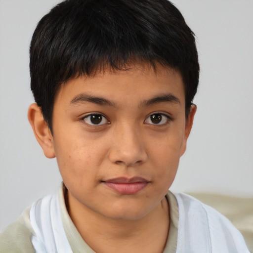 Joyful latino child male with short  brown hair and brown eyes
