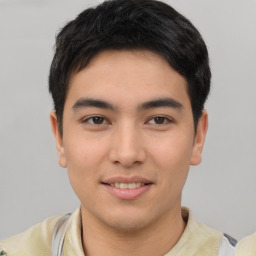 Joyful asian young-adult male with short  brown hair and brown eyes