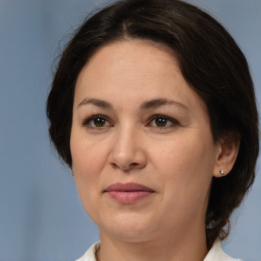 Joyful white adult female with medium  brown hair and brown eyes