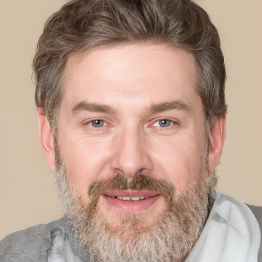 Joyful white adult male with short  brown hair and grey eyes