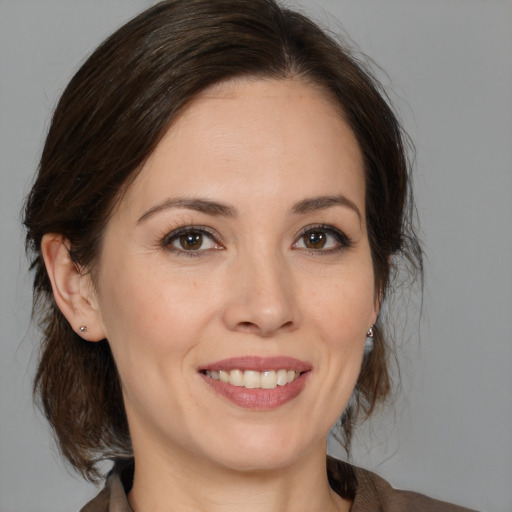 Joyful white young-adult female with medium  brown hair and brown eyes