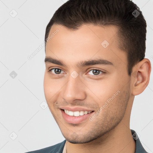 Joyful white young-adult male with short  brown hair and brown eyes