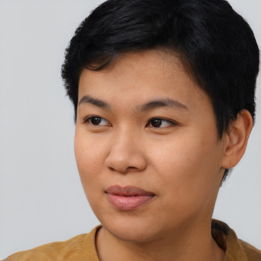 Joyful asian young-adult female with short  black hair and brown eyes
