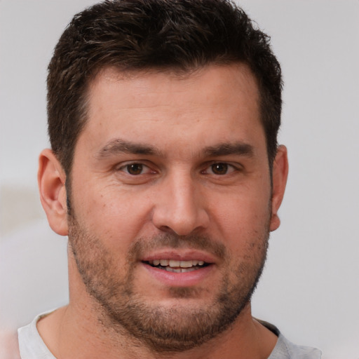 Joyful white young-adult male with short  brown hair and brown eyes