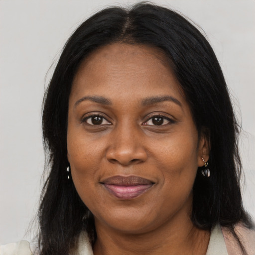 Joyful black young-adult female with long  brown hair and brown eyes