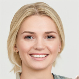 Joyful white young-adult female with medium  brown hair and blue eyes