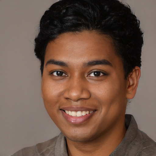 Joyful black young-adult male with short  brown hair and brown eyes