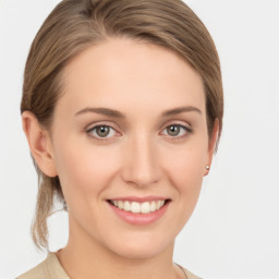 Joyful white young-adult female with medium  brown hair and grey eyes