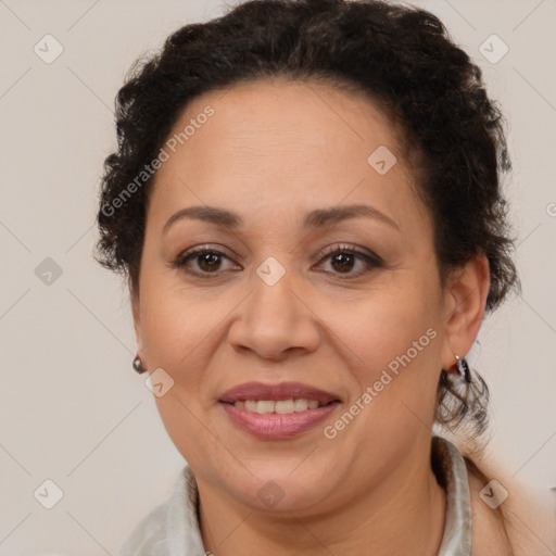 Joyful latino adult female with medium  brown hair and brown eyes