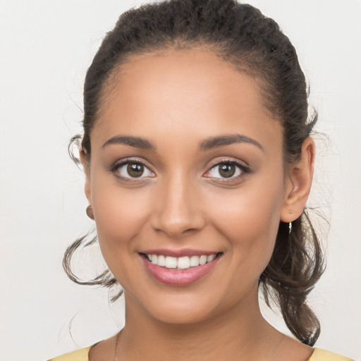 Joyful white young-adult female with long  brown hair and brown eyes