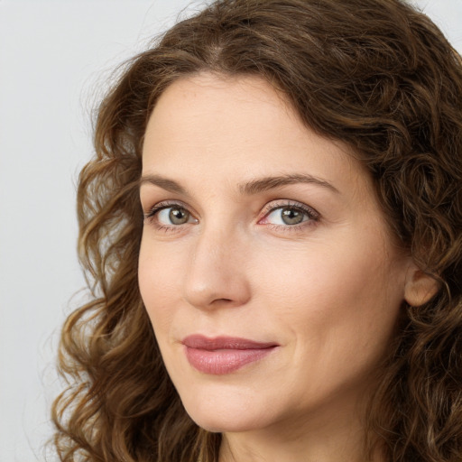 Joyful white young-adult female with long  brown hair and green eyes