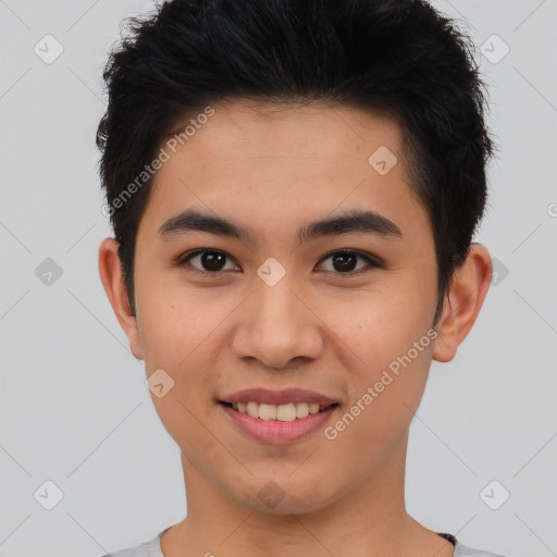 Joyful asian young-adult male with short  brown hair and brown eyes