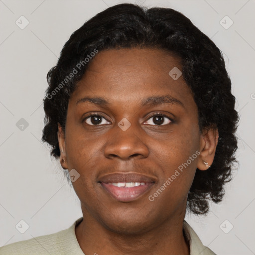 Joyful black young-adult female with short  black hair and brown eyes