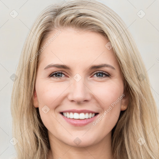 Joyful white young-adult female with long  brown hair and brown eyes