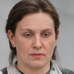 Joyful white adult female with medium  brown hair and grey eyes