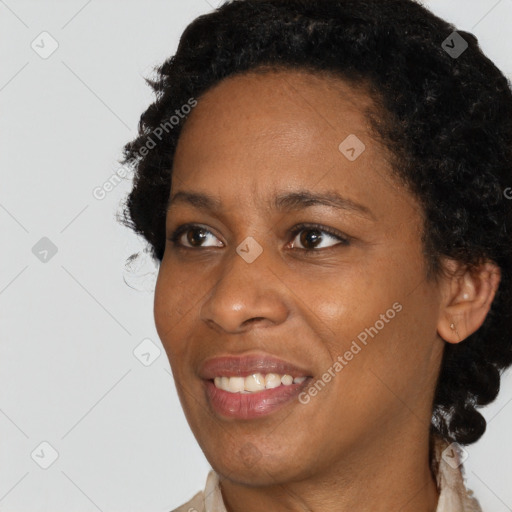 Joyful black young-adult female with short  brown hair and brown eyes