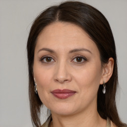 Joyful white adult female with long  brown hair and brown eyes