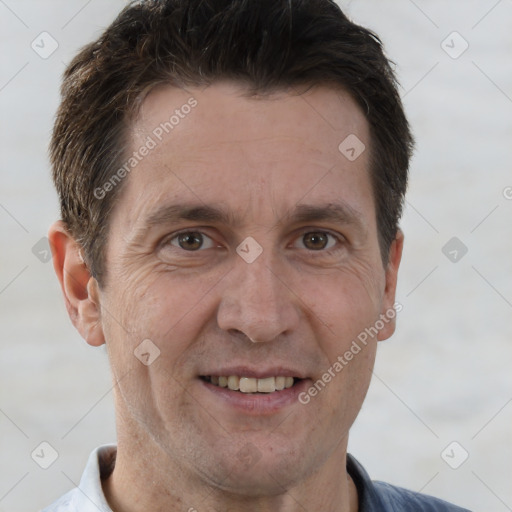 Joyful white adult male with short  brown hair and brown eyes