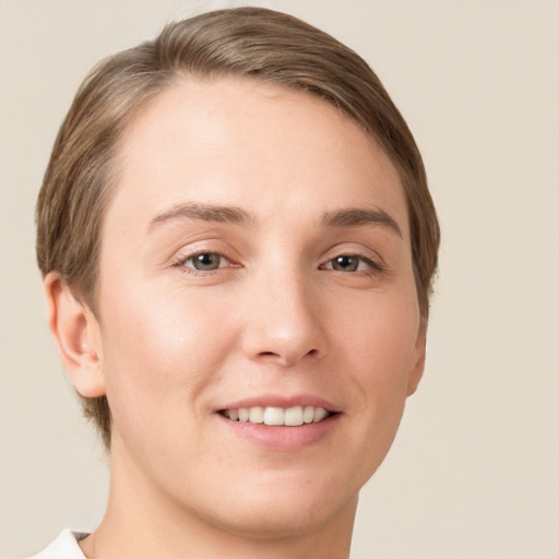 Joyful white young-adult female with short  brown hair and grey eyes