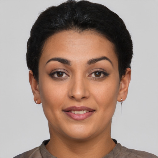 Joyful latino young-adult female with short  black hair and brown eyes