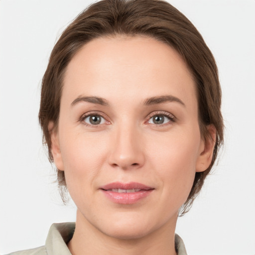 Joyful white young-adult female with medium  brown hair and grey eyes