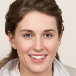 Joyful white young-adult female with medium  brown hair and blue eyes