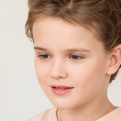 Joyful white child female with short  brown hair and brown eyes