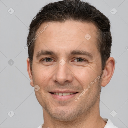 Joyful white adult male with short  brown hair and brown eyes