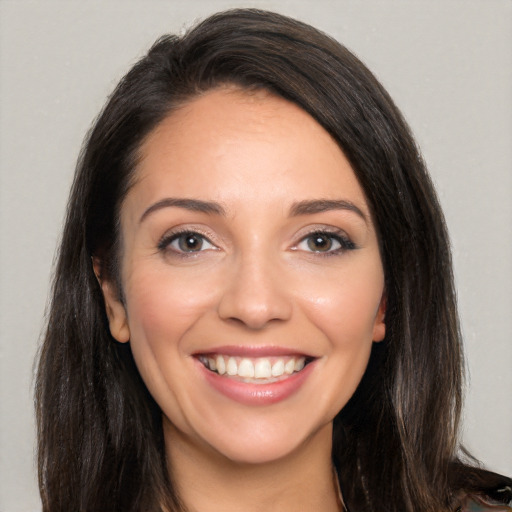 Joyful white young-adult female with long  brown hair and brown eyes