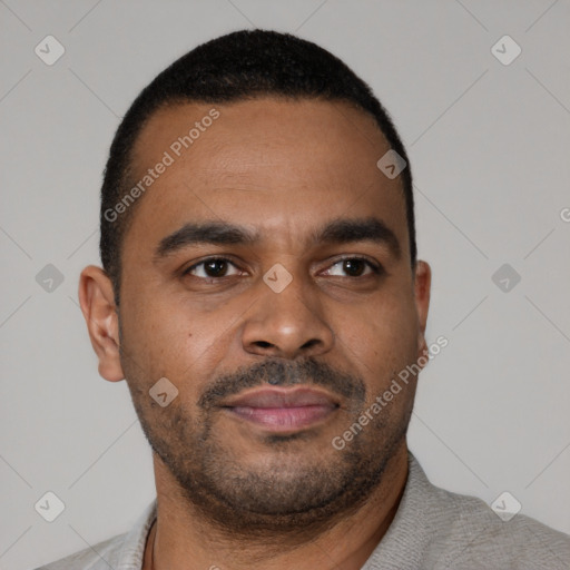 Joyful latino young-adult male with short  brown hair and brown eyes