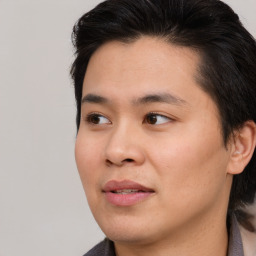 Joyful asian young-adult male with medium  brown hair and brown eyes