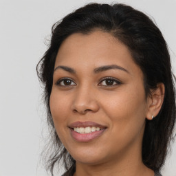 Joyful latino young-adult female with long  brown hair and brown eyes