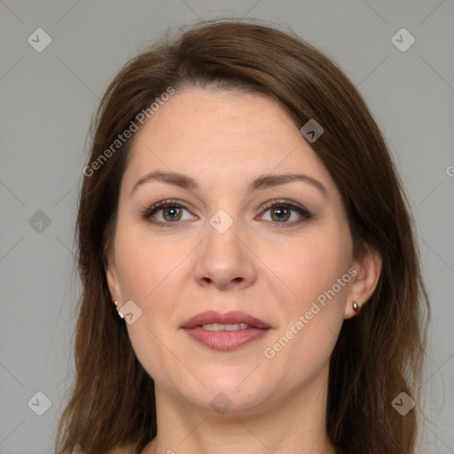 Joyful white adult female with long  brown hair and grey eyes