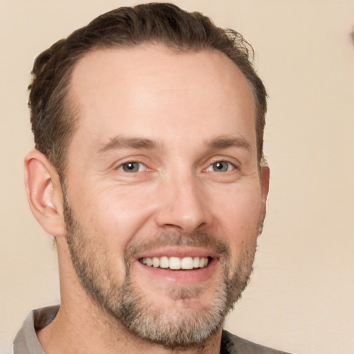 Joyful white adult male with short  brown hair and brown eyes