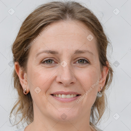 Joyful white adult female with medium  brown hair and grey eyes